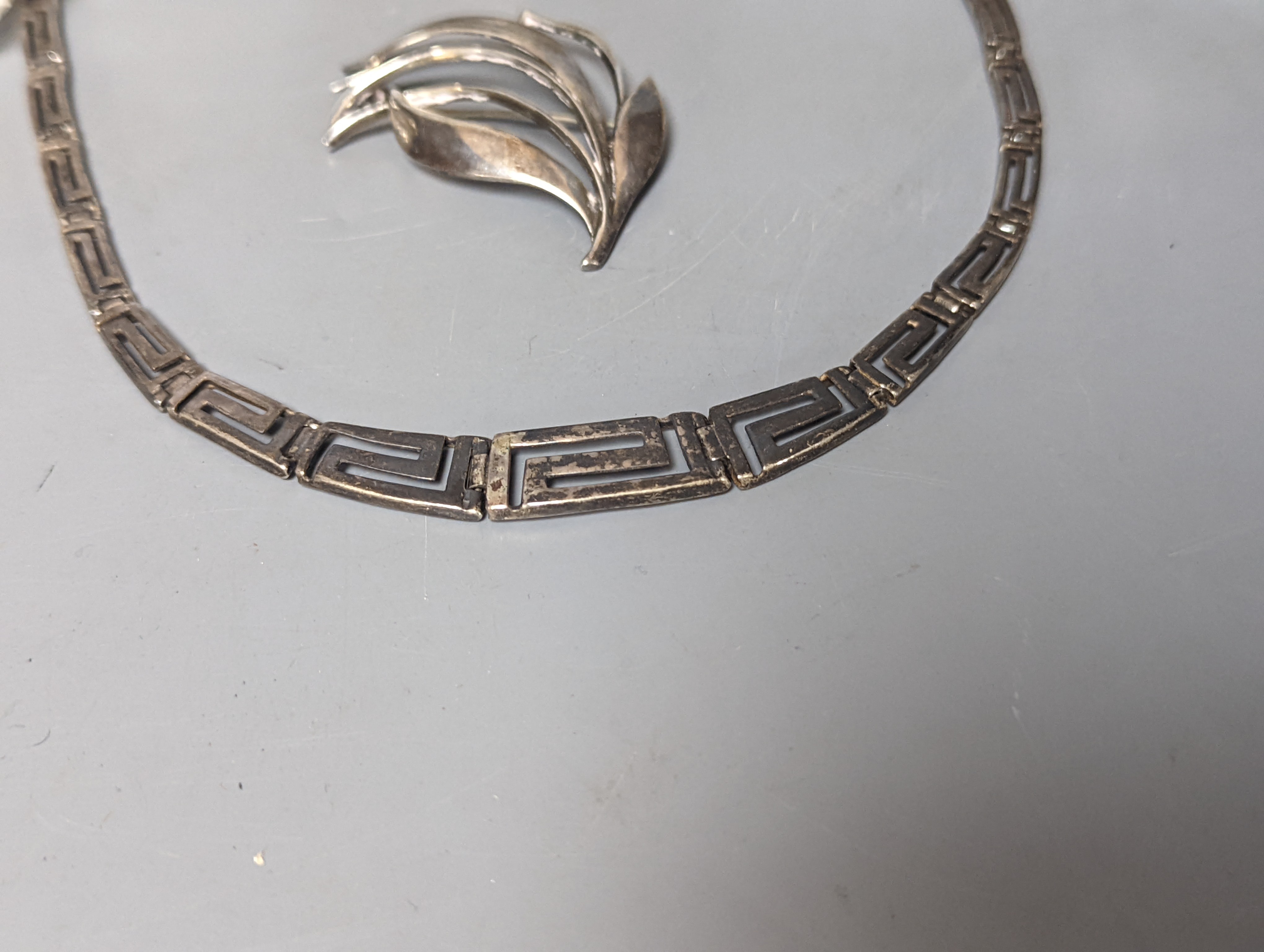 A Danish sterling foliate brooch, 5cm, a 925 'Greek Key' necklace and three silver mounted glass items including an early 20th century match tidy.